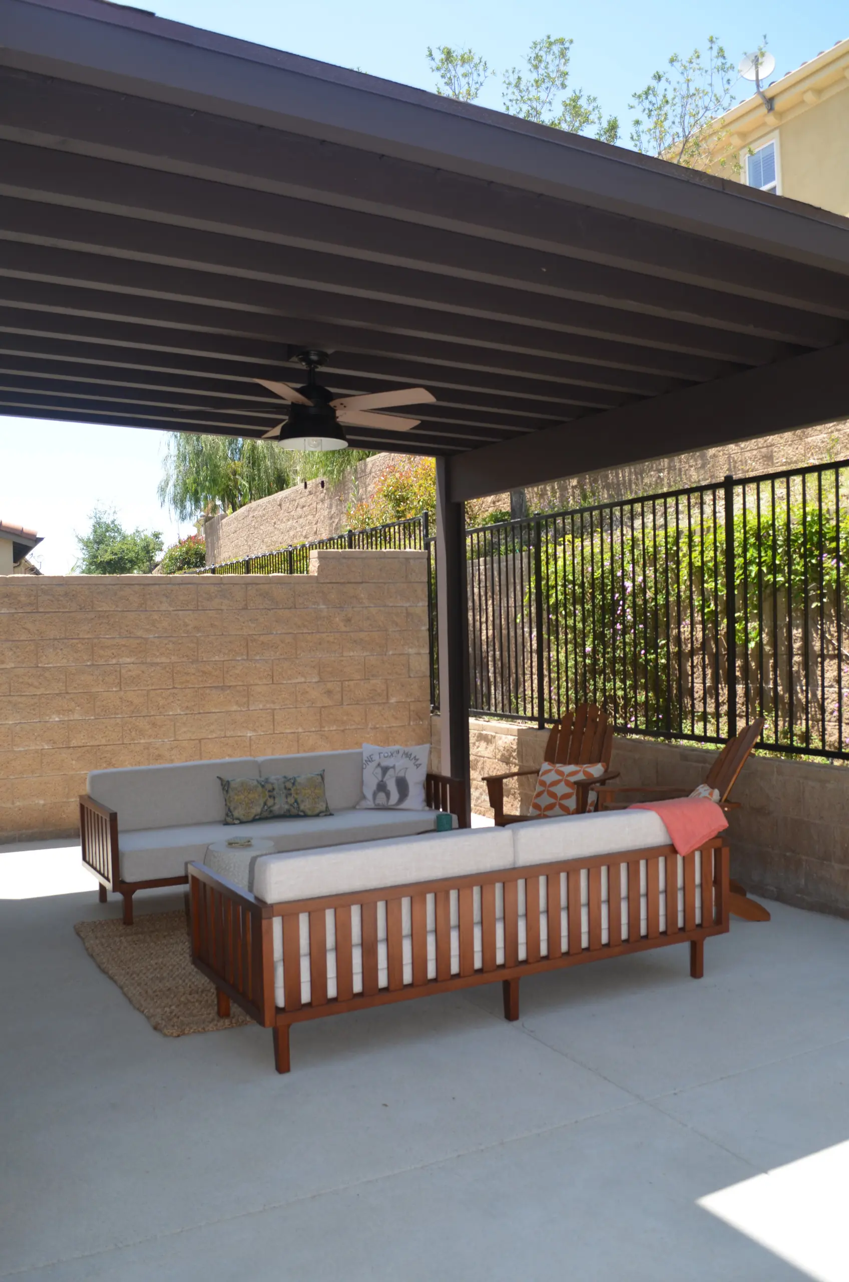 Covered patio with ceiling fan and lounge seating in Irvine